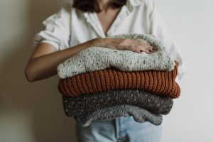 Kobieta trzyma swetry